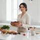 تغذیه و زیبایی پوست و مو؛ چیدمان خوراکی های مفید مثل میوه، سبزیجات و ماهی در کنار ابزار مراقبت و آرایش با نور روشن مجله ای